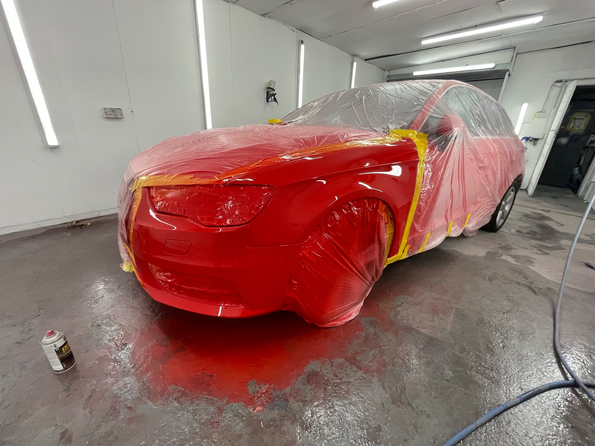 Red car freshly resprayed to a deep gloss