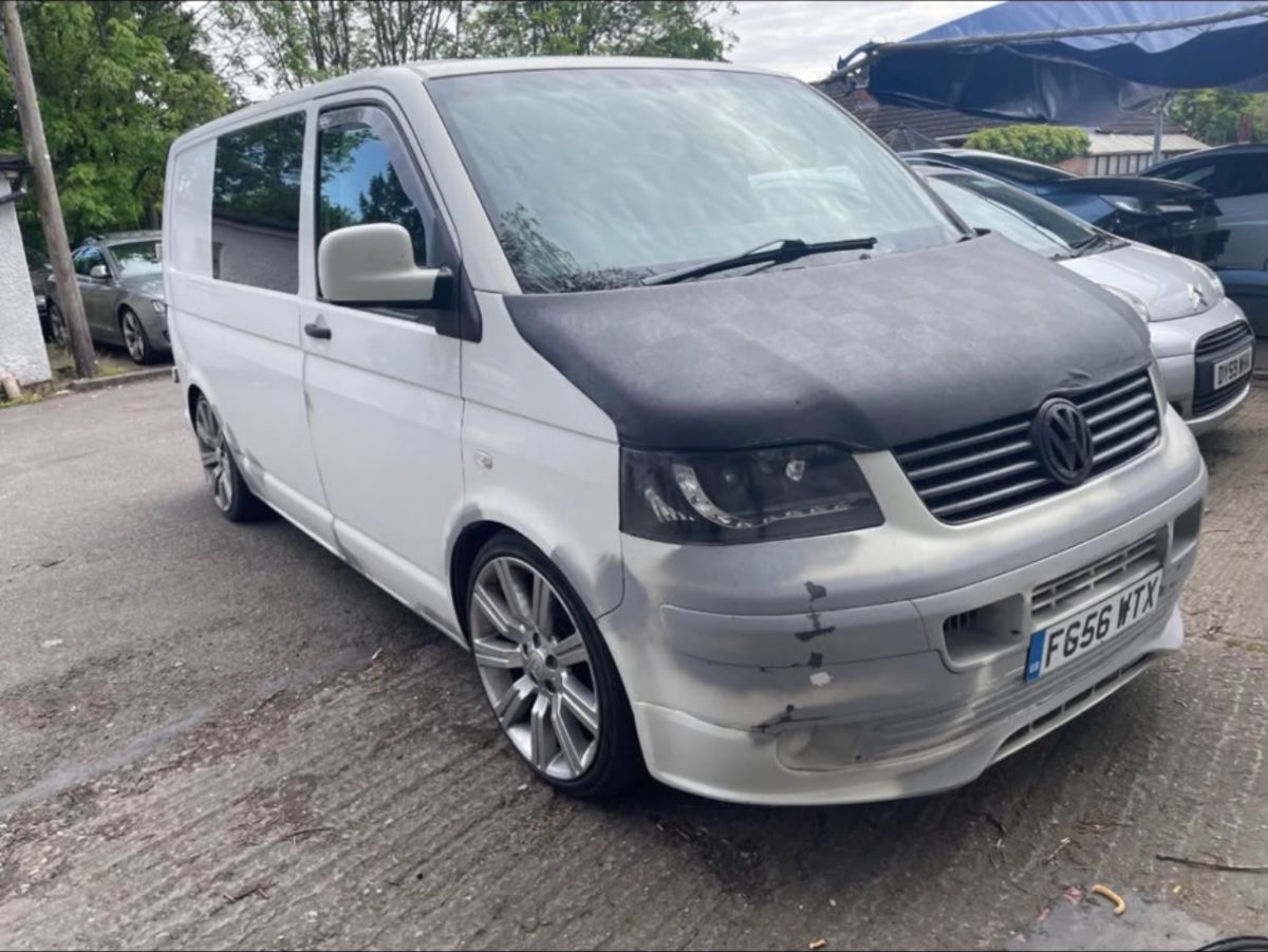 White VW Transporter with front-end accident damage